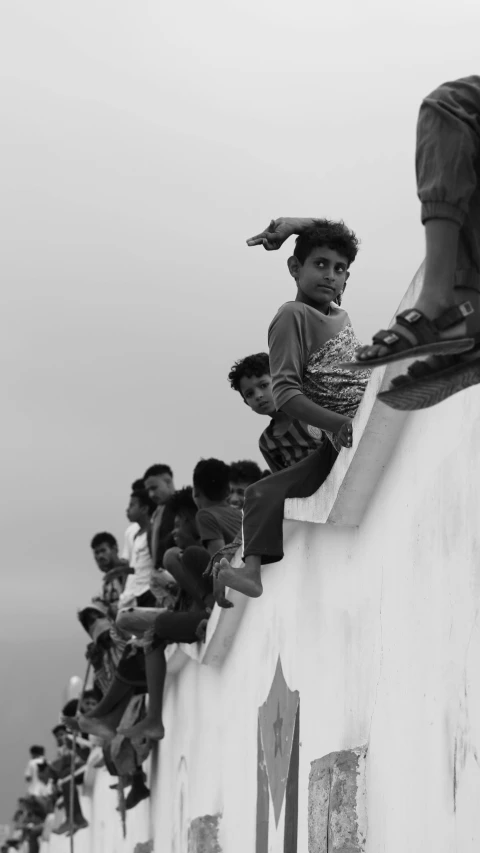 a small child is standing on the ledge of a building