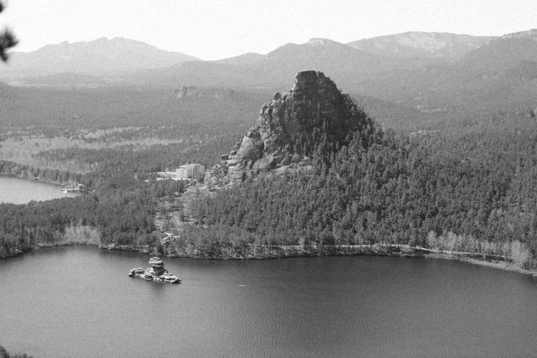 a small boat sailing through the water near some mountains