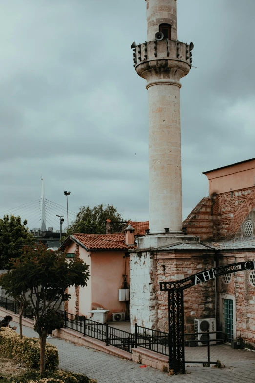 a tall tower on a street in the rain