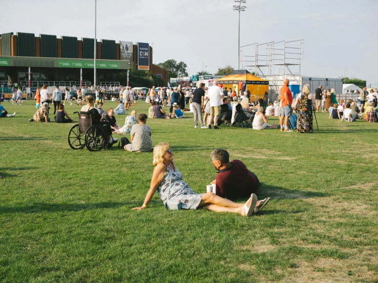 people in the park sitting on the grass