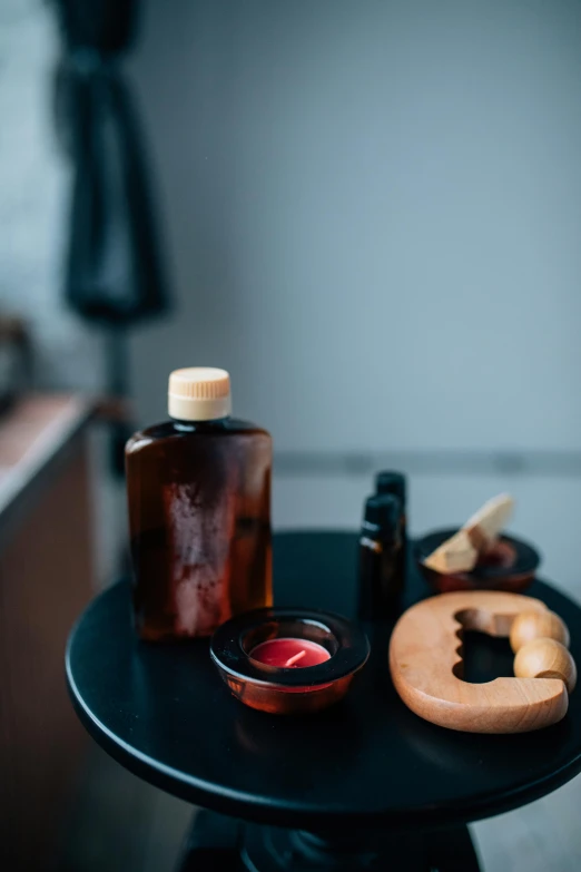 the bottle and several miniature bottles are sitting on the black table