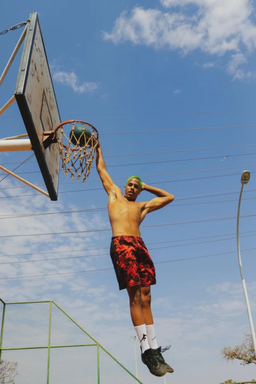 a man about to dunk a basketball in the court