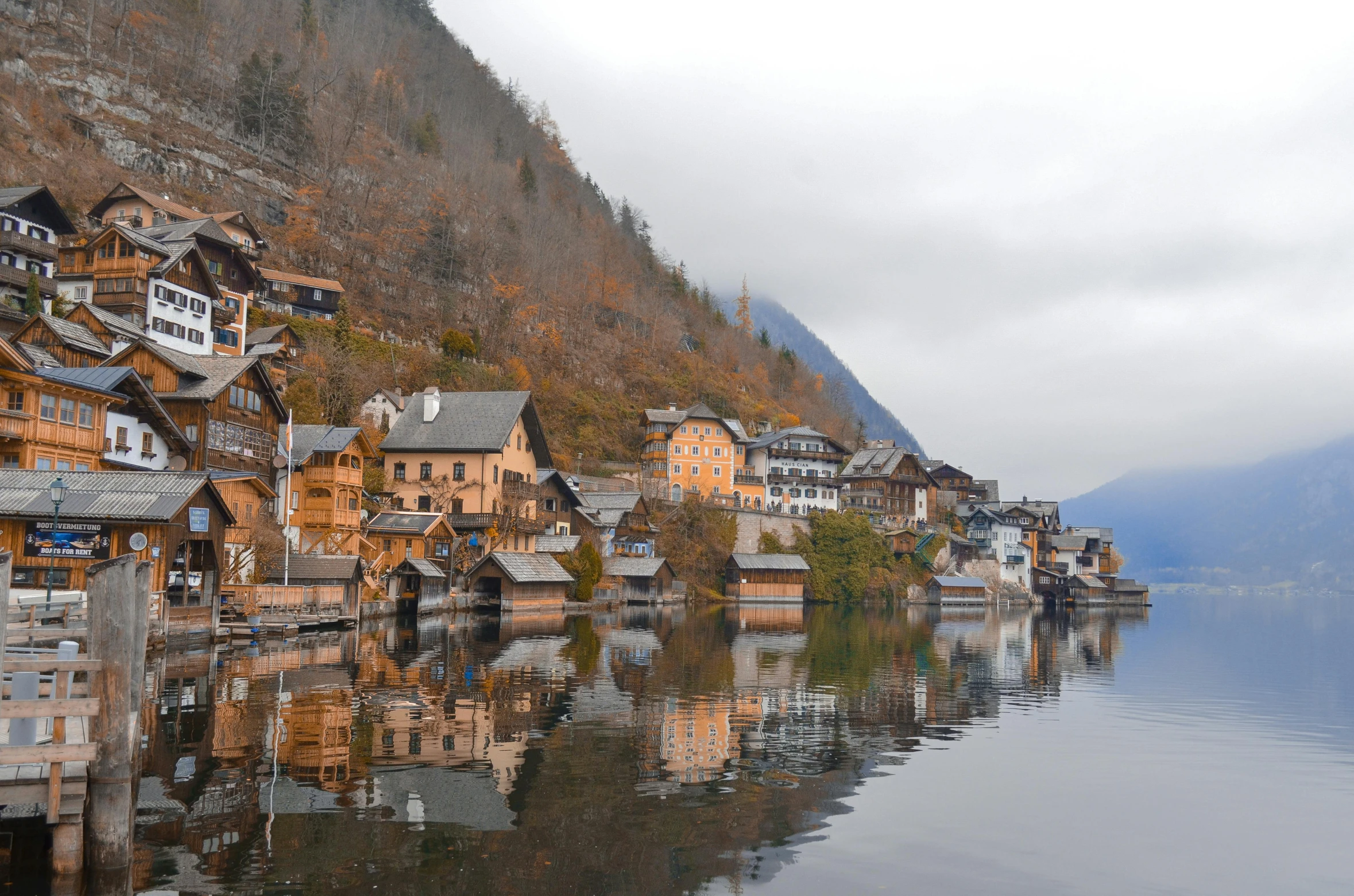 a village on a mountain with a lake in front of it