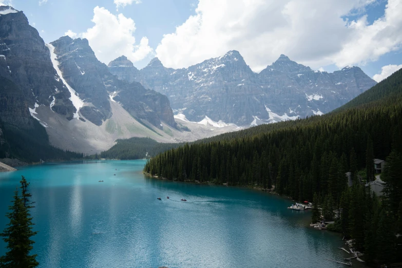 a river running through a valley with trees around