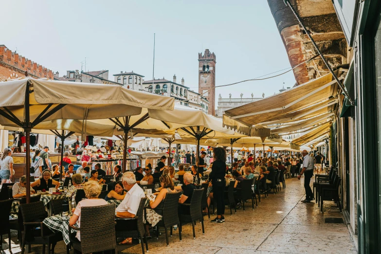 an outdoor dining area with large open umbrellas and tables with seating