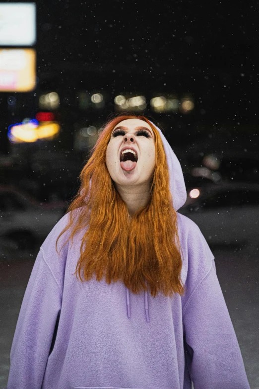a red haired woman yawns as she looks up into the sky