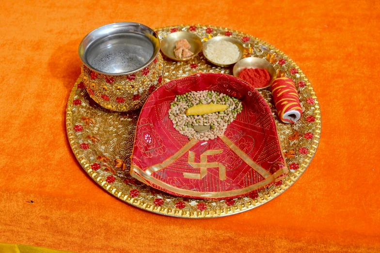 a plate with various items on an orange cloth