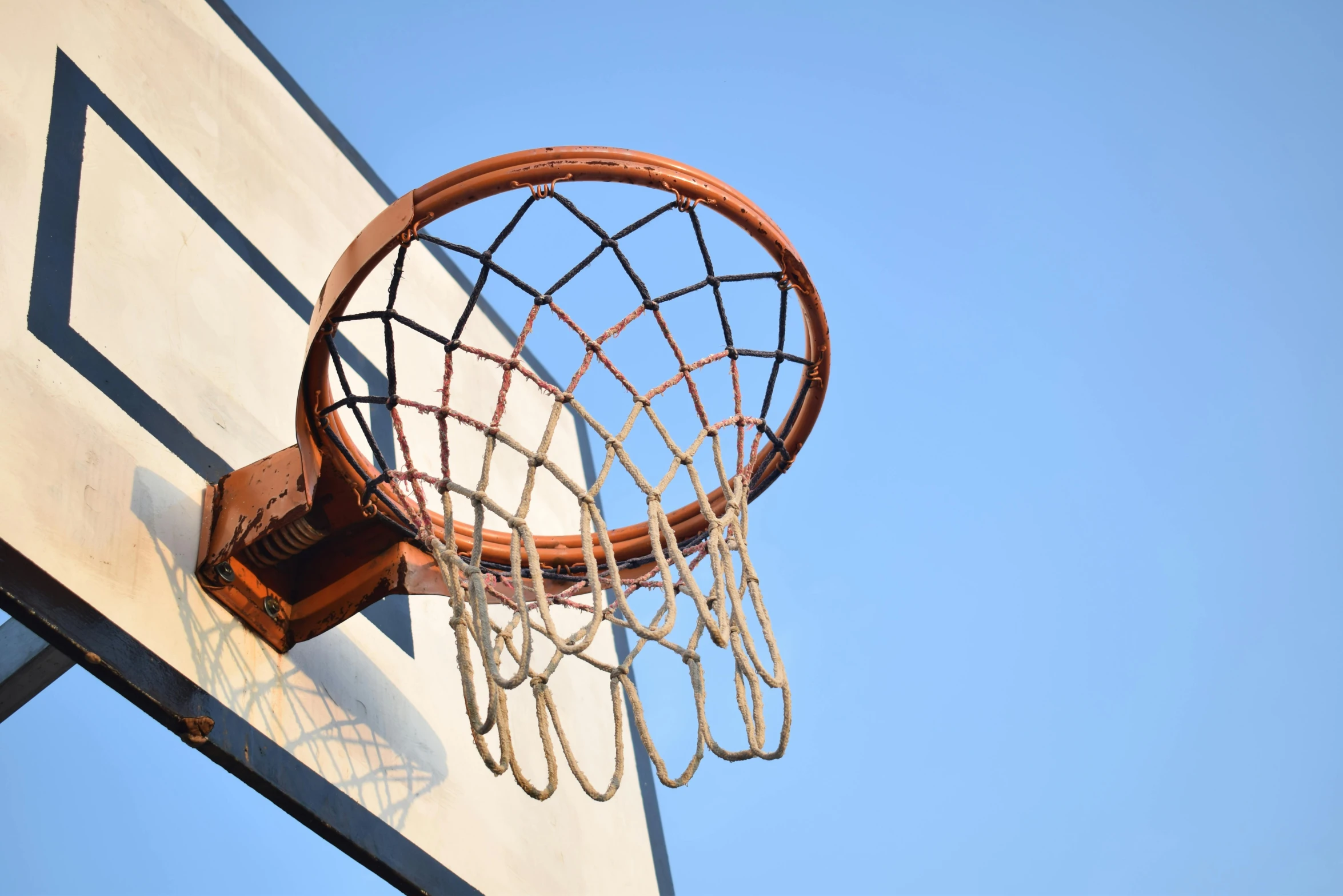 an old basketball is being pulled into the net