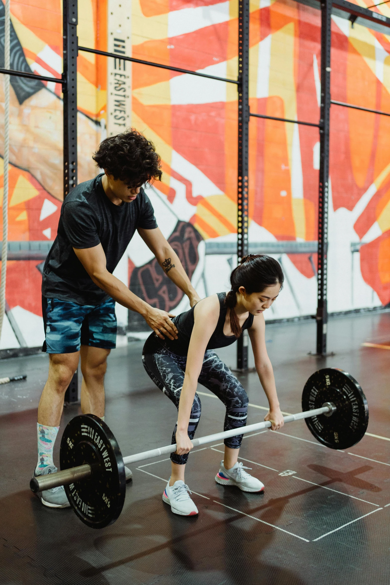 a woman lifting a barbell during a crossfit class