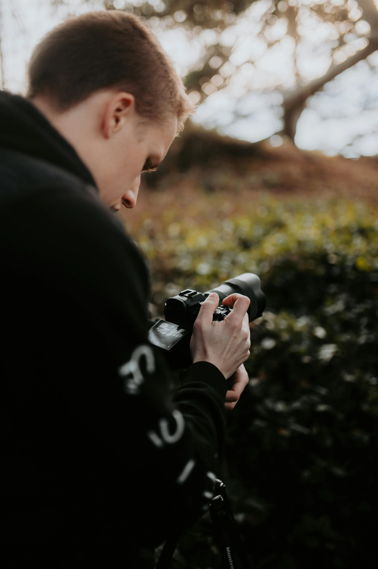 the young man is holding up his camera