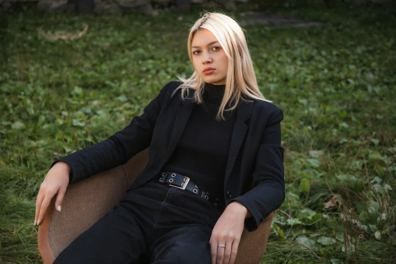 woman in black sitting on the ground and staring straight ahead