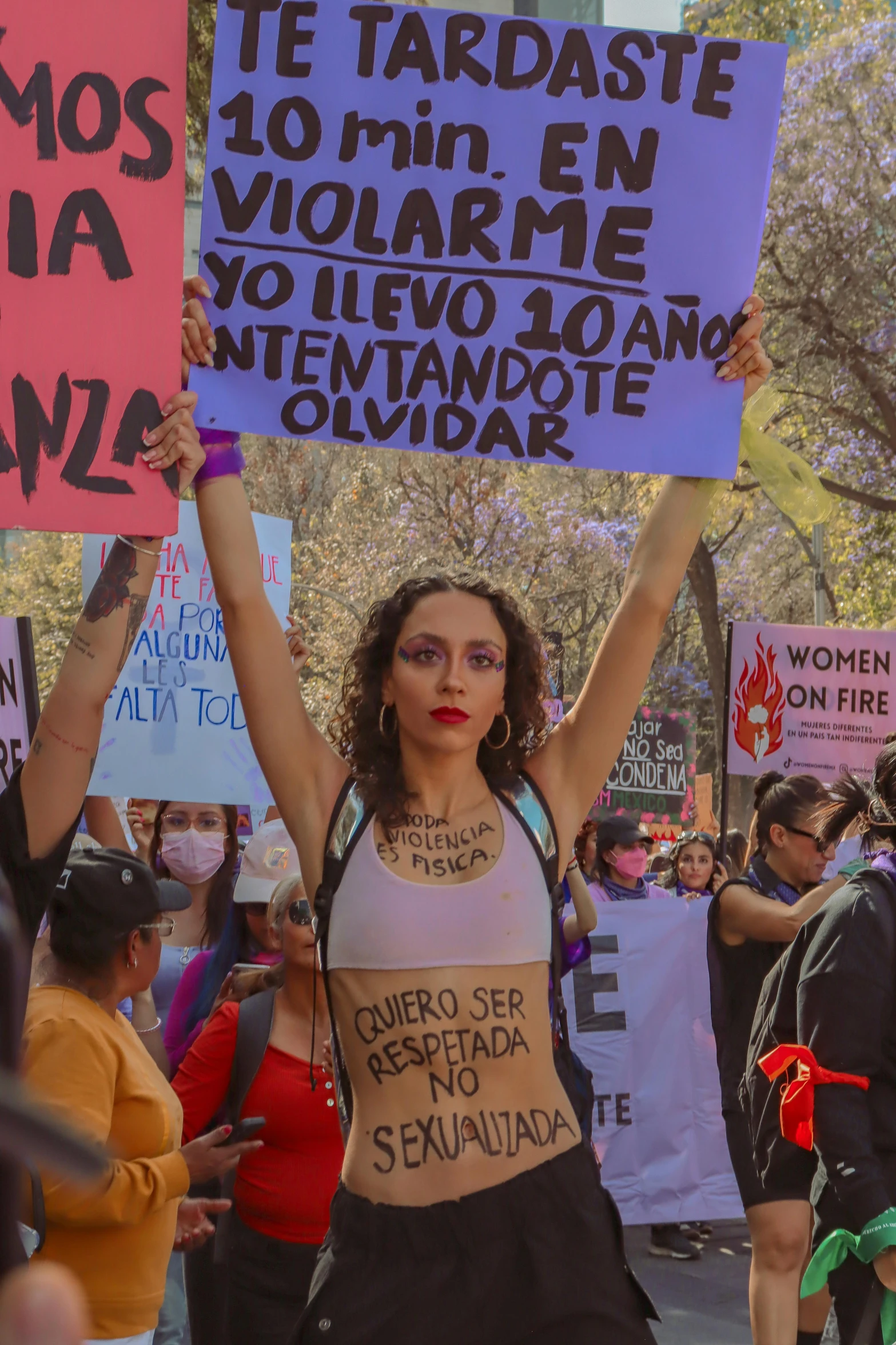 a woman with a sign for women on a city street