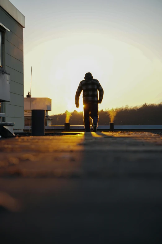 a man is walking down the road towards a building