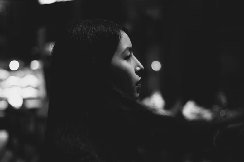 a black and white po of a woman staring ahead