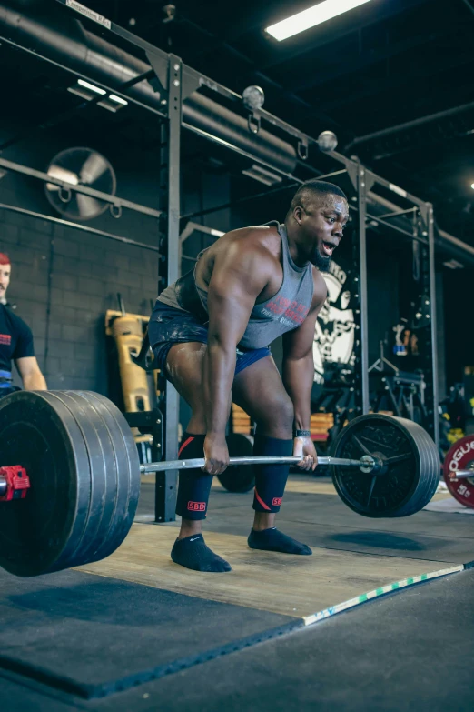 a man working out in a gym with a barbell