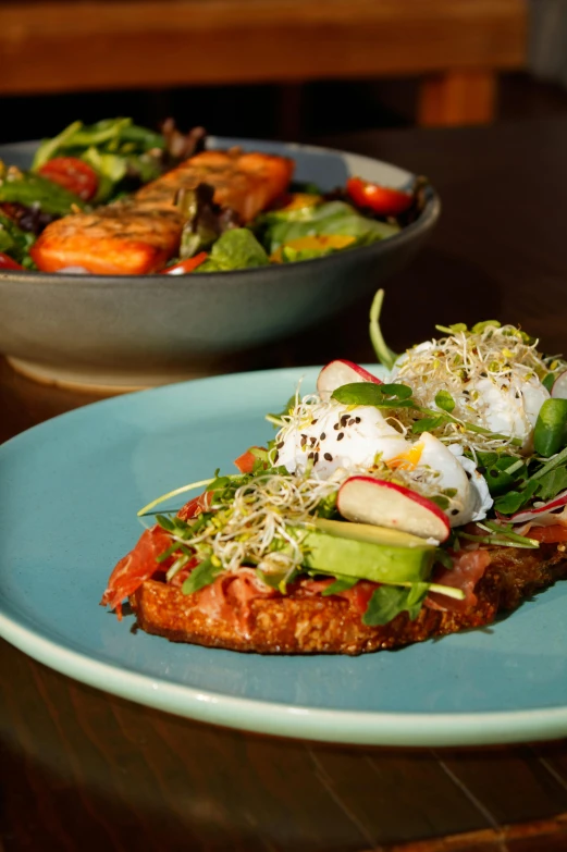 two plates with food on them sitting on a table