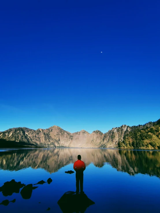 a person standing in the water on a bright day