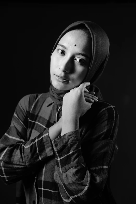 black and white pograph of a woman wearing a head scarf