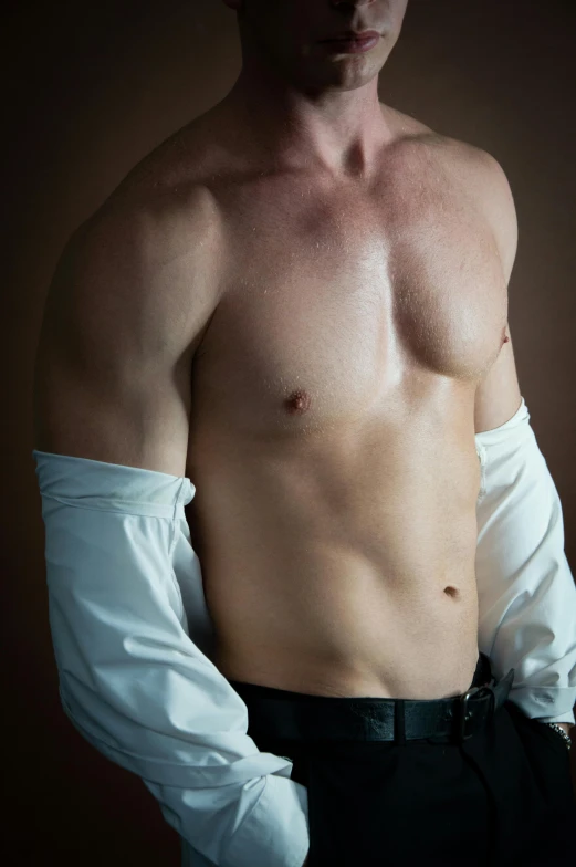 a shirtless man posing for a pograph