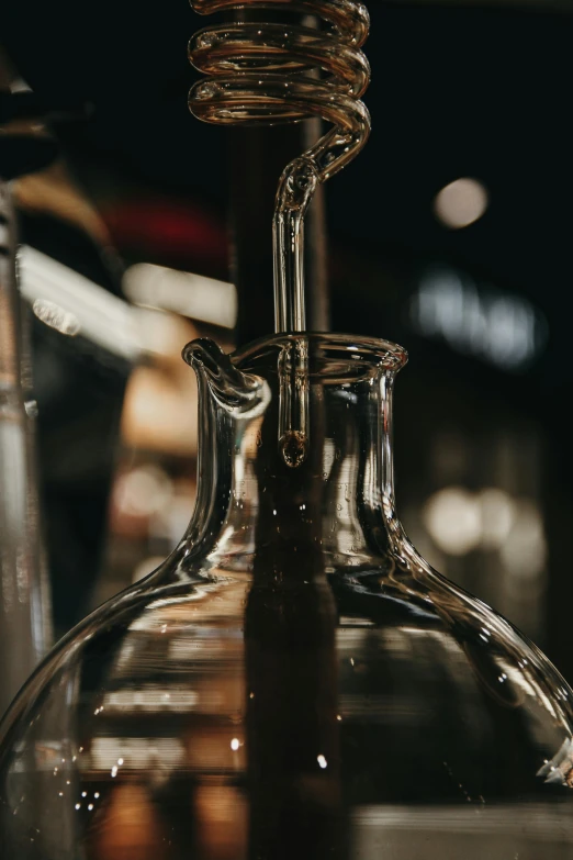 an empty glass bottle and an empty wine glass