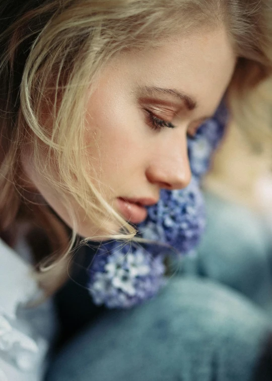 a woman wearing an earring with flowers on it