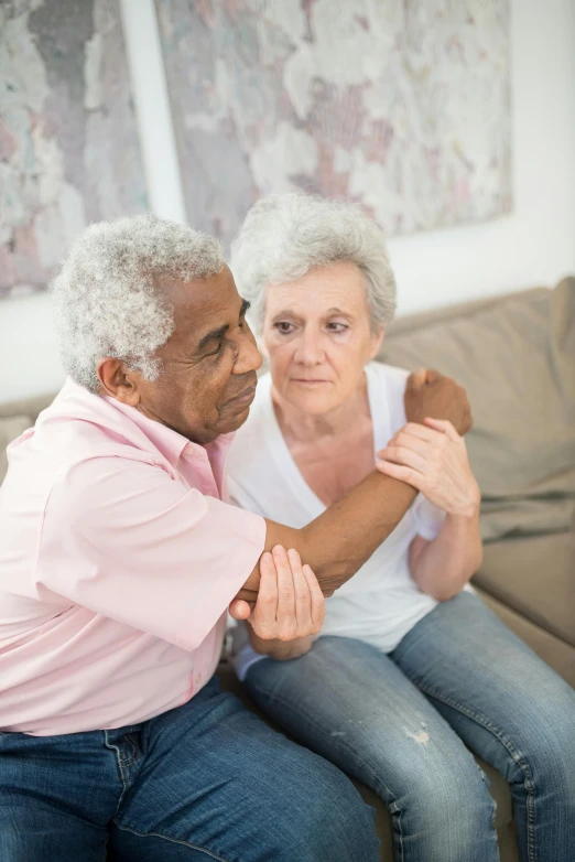 a man and a woman sitting on top of a couch