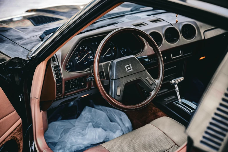 the interior of a vehicle has a brown dashboard and tan leather