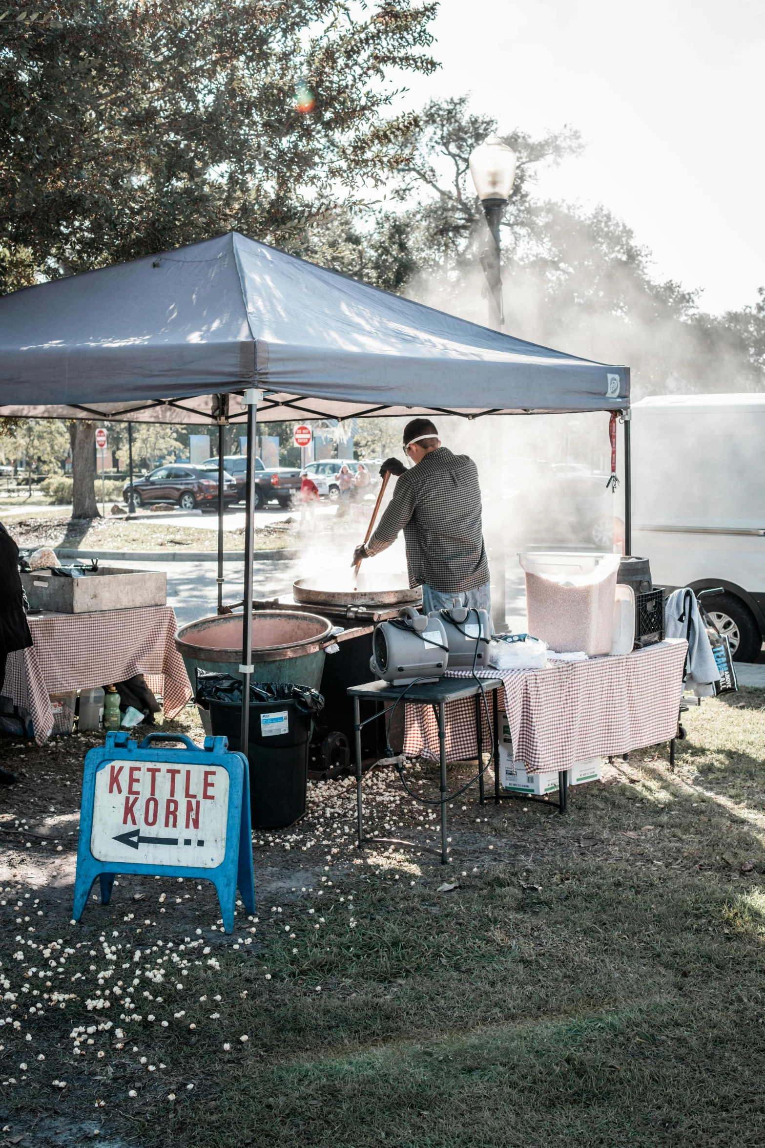 a person cooking food on a grill under a tent