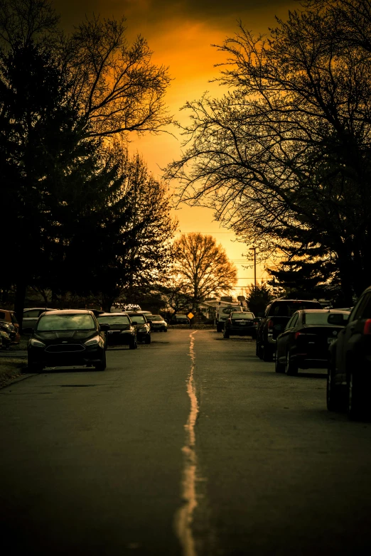 several cars are parked on a quiet street