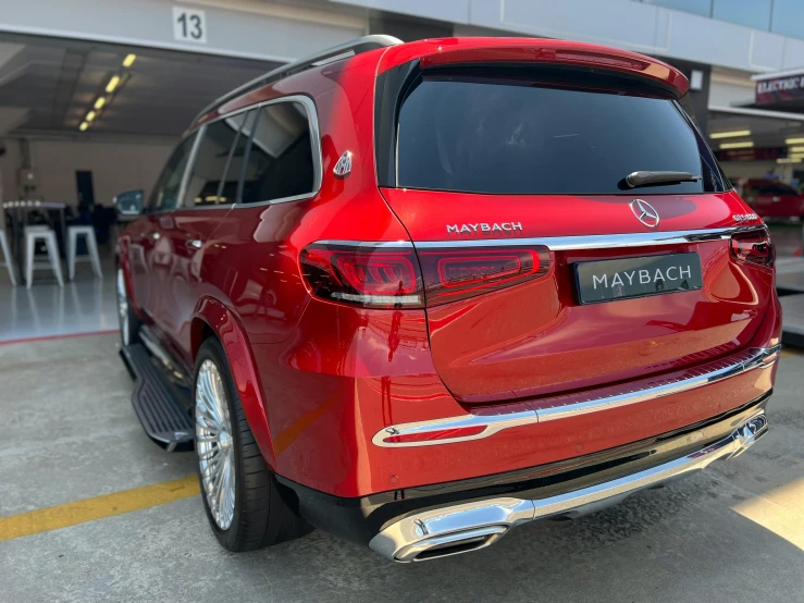 a red toyota may palace suv parked inside a building