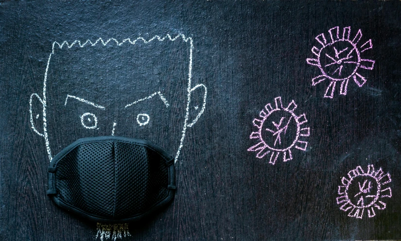 a chalk drawing of a person has been placed on a black board