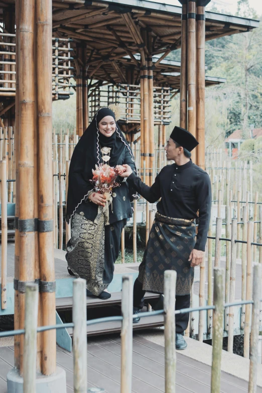 woman in a traditional korean costume shaking hands with a man in an overcoat and hat