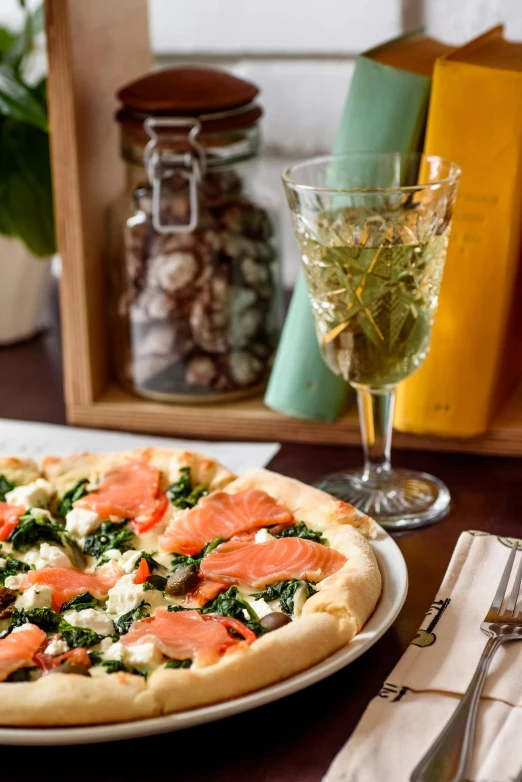 a pizza sitting on a white plate next to a cup