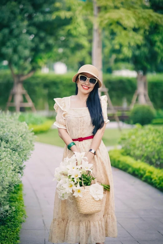 the woman is wearing a tan dress and hat