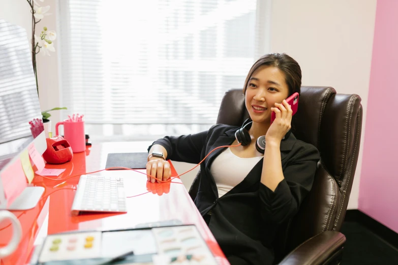 a woman smiling while talking on her phone