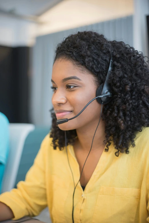 a person wearing a headset looking at a computer screen