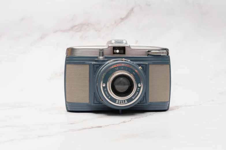 an old style camera is sitting on a marble surface