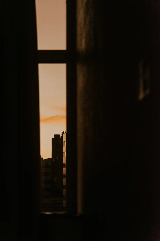 a view from a window into some buildings at night