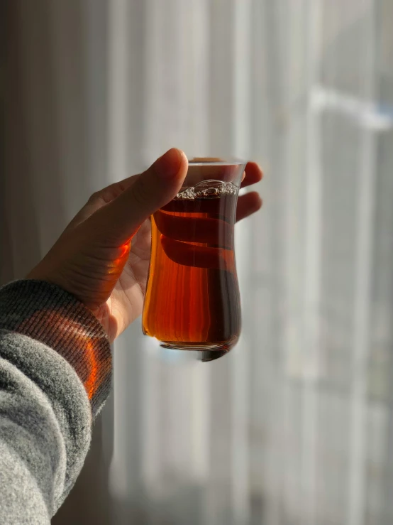 a person holding a cup with soing outside of it