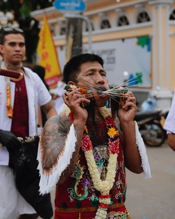 the man in this costume is playing with sticks