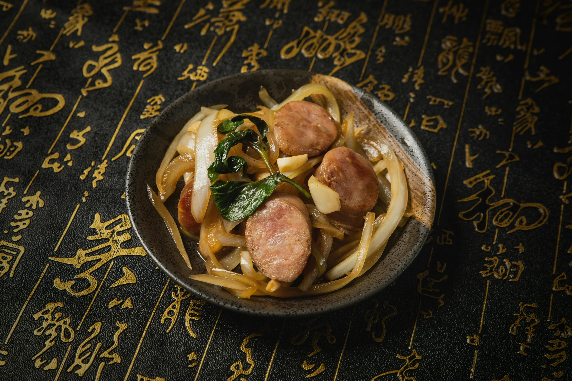 some food is in a small metal bowl on a table