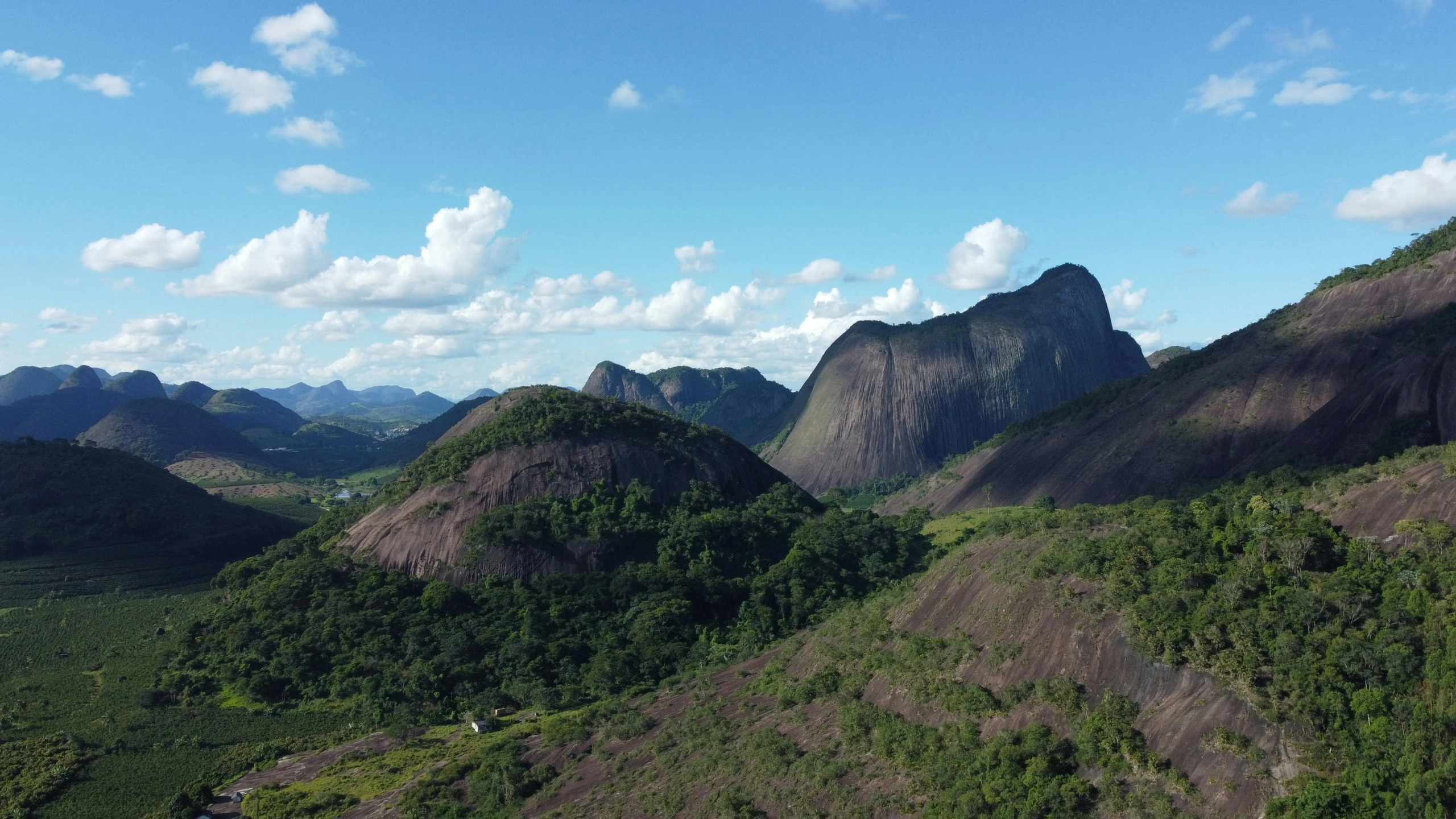 an aerial view of a valley and mountains