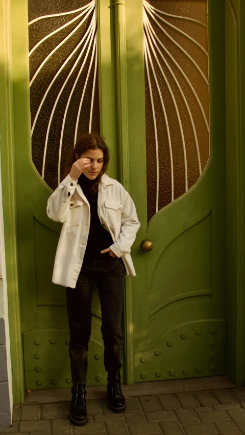 woman posing for camera in front of door of house