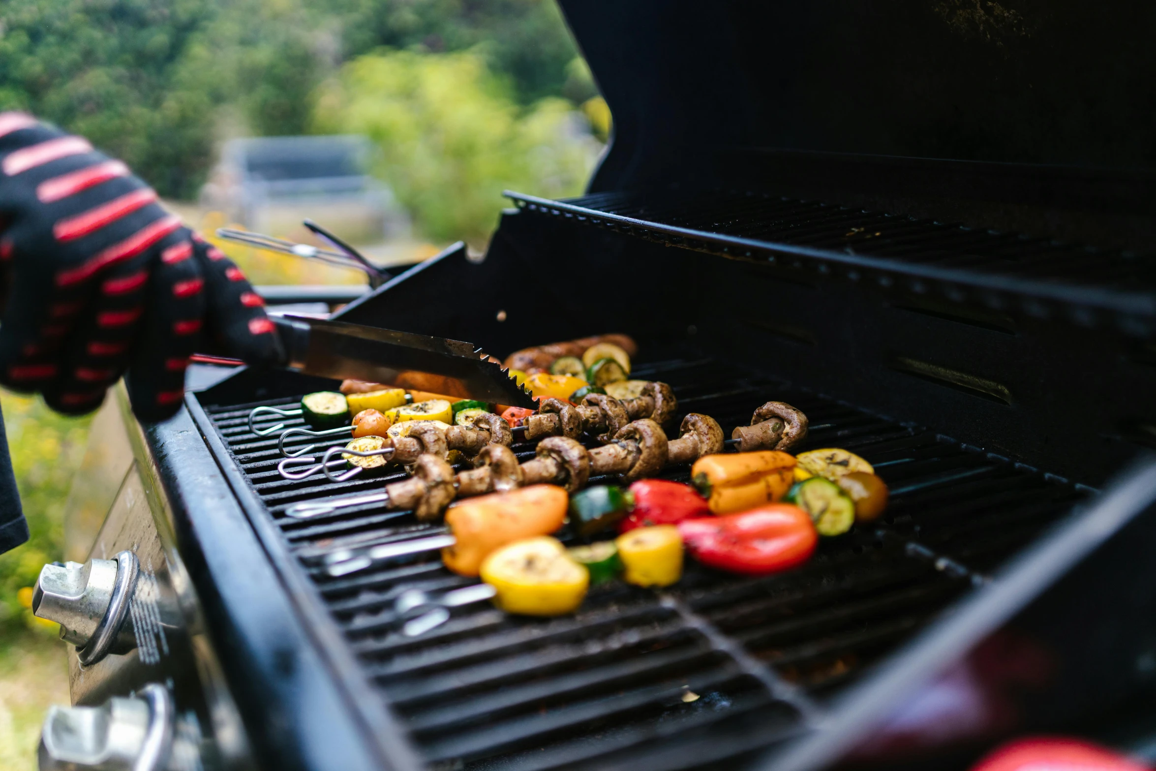 meat is cooking on a grill outside