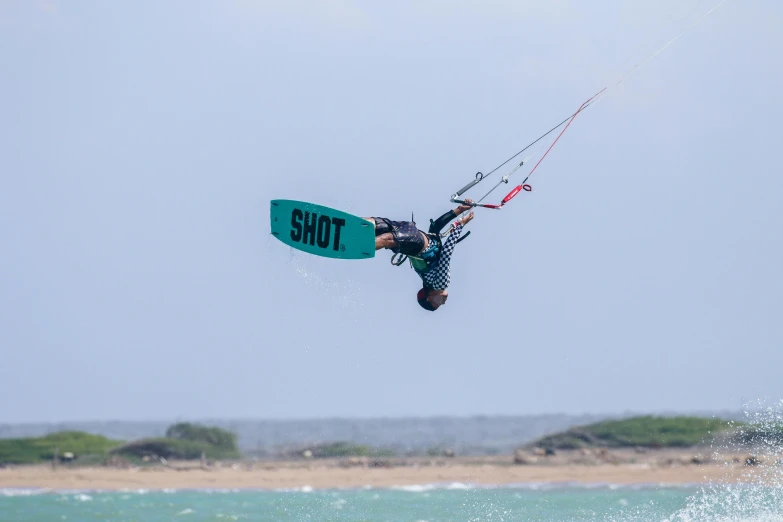 the wind surfer is enjoying his board trick