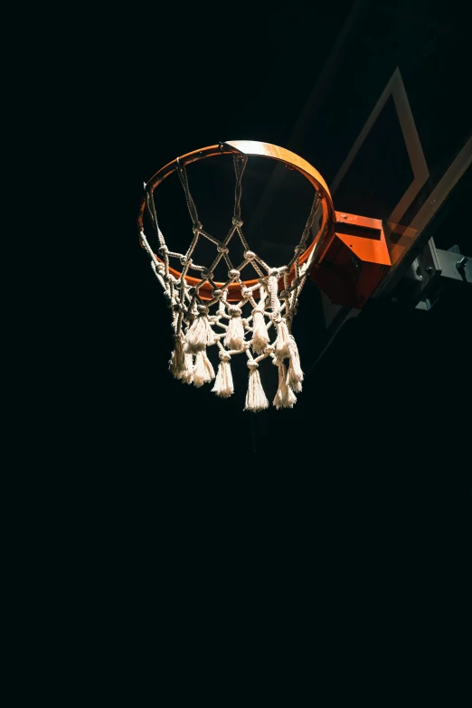 a basketball is in the air with white tassels