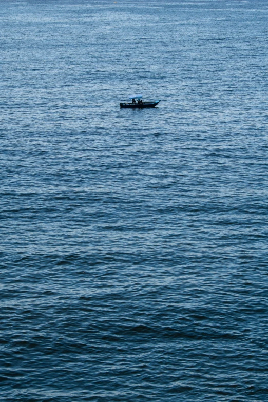 a small boat in the water with some waves