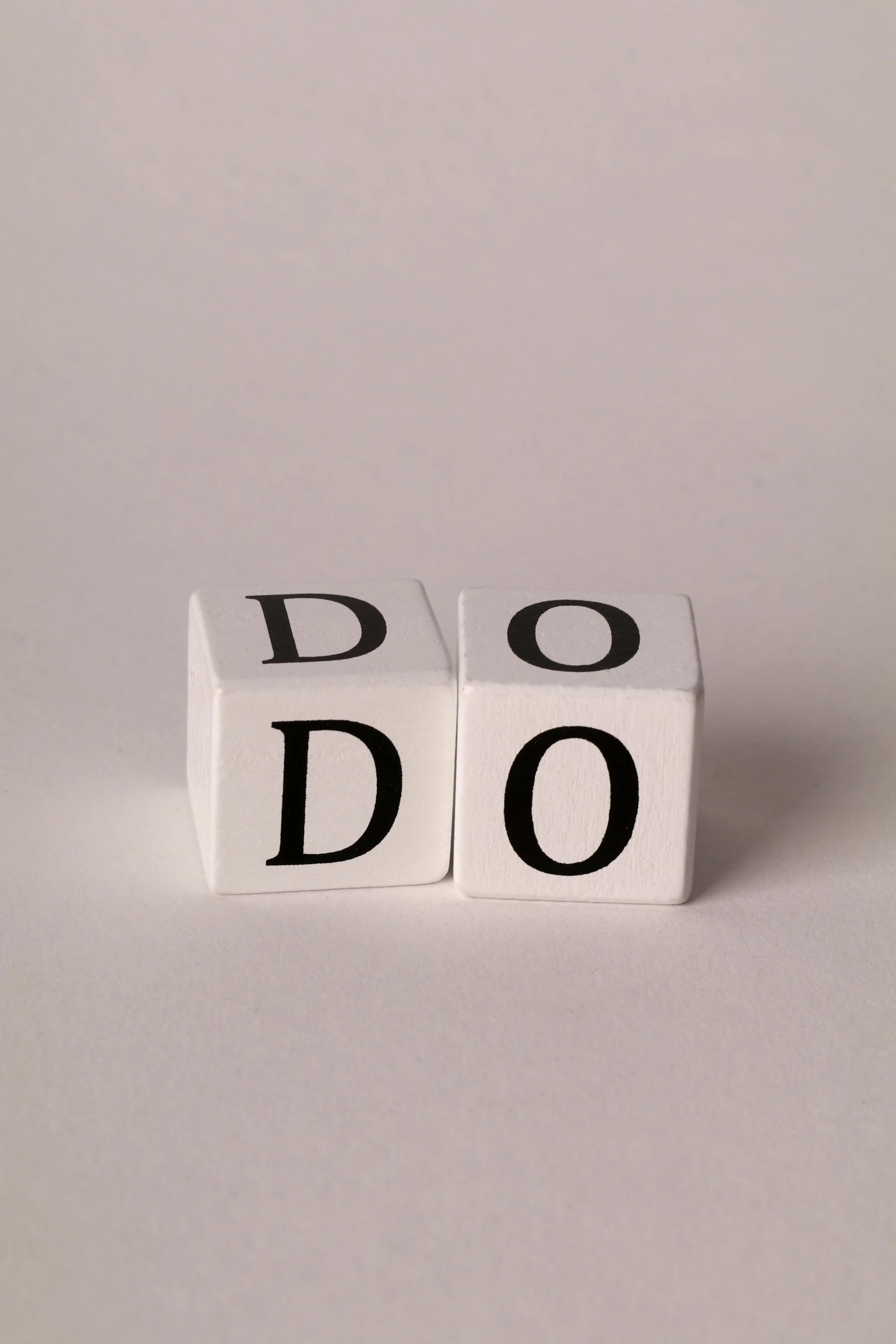 a pair of dice spelling do and don in a square