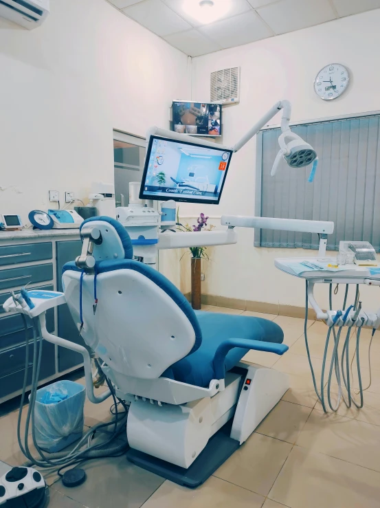 a dentist's office has a television and monitors