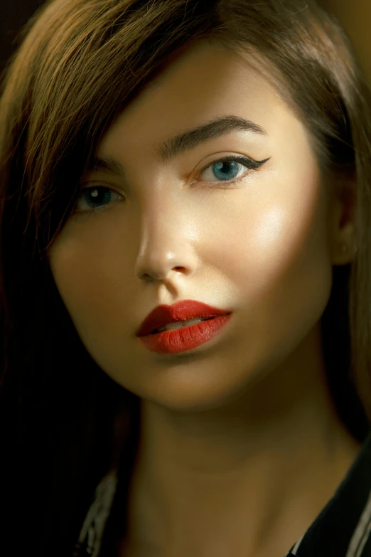 woman with makeup on face with bright orange liquid